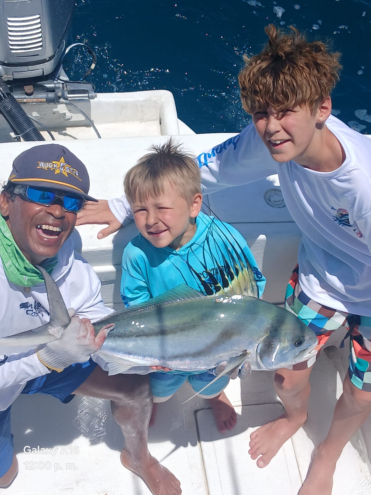 Captain and kids with a roosterfish